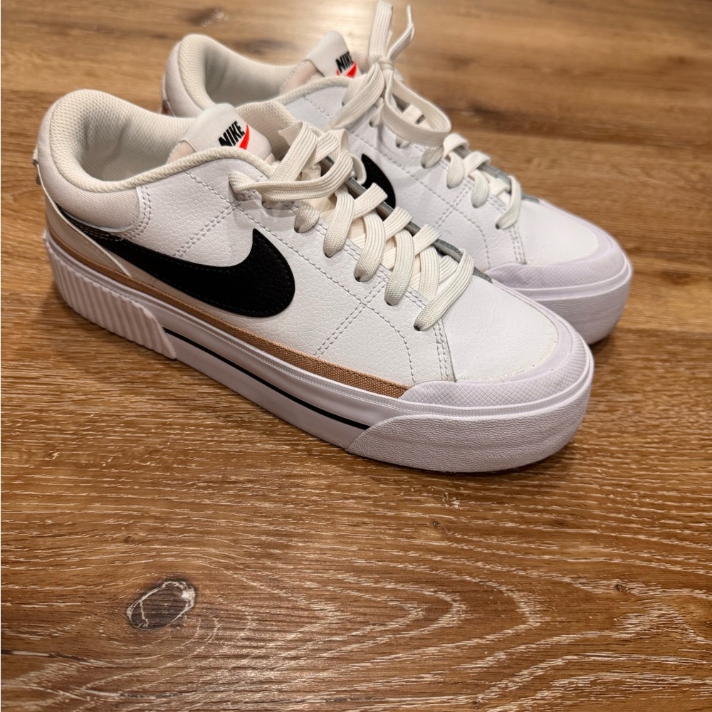 Nike White Sneakers with Black Swoosh and Gold Stripe